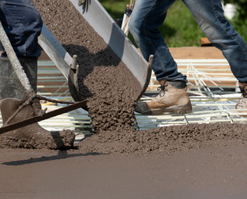 Workers Pouring Concrete For A Stamped Floor